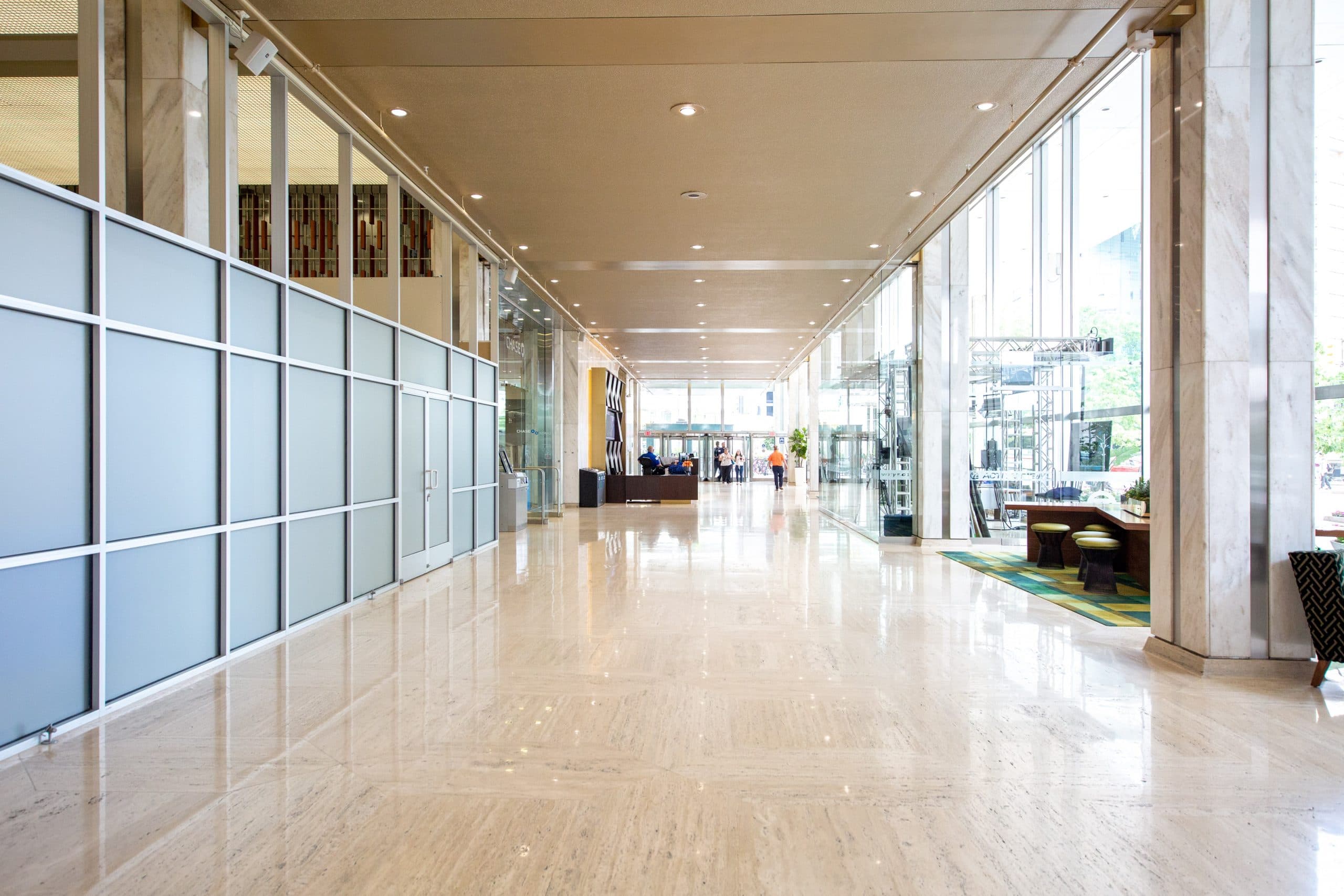 Chase Tower Lobby set with soft seating, 24 hour security desk and natural lighting from the floor to ceiling windows."